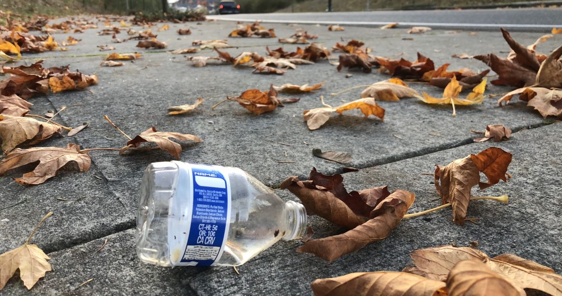 Discarded plastic water bottle on the sidewalk